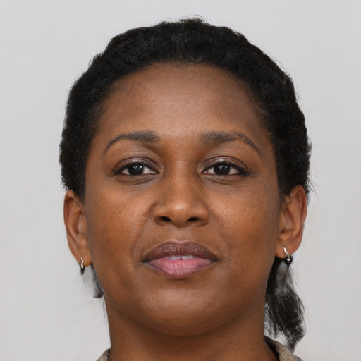 Joyful black young-adult female with short  brown hair and brown eyes