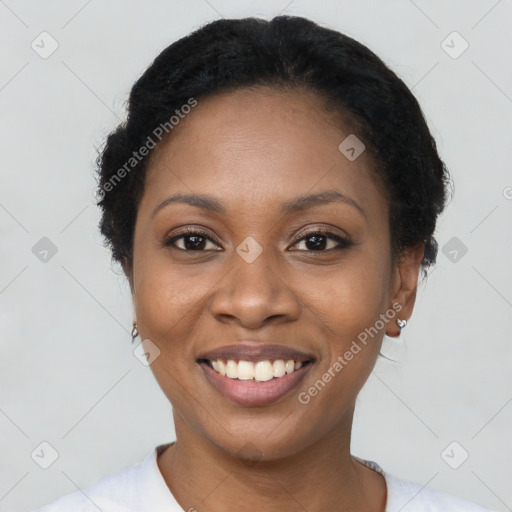 Joyful black young-adult female with short  black hair and brown eyes