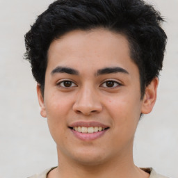 Joyful latino young-adult male with short  brown hair and brown eyes