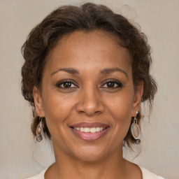 Joyful white adult female with medium  brown hair and brown eyes