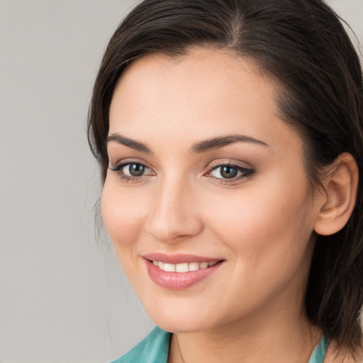 Joyful white young-adult female with medium  brown hair and brown eyes