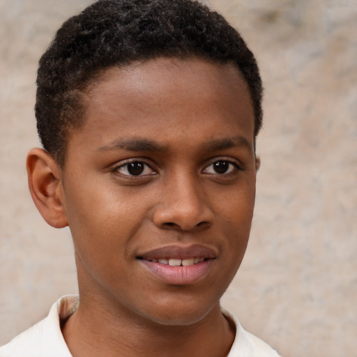 Joyful black child male with short  brown hair and brown eyes