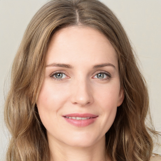 Joyful white young-adult female with long  brown hair and green eyes