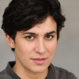 Joyful white young-adult male with medium  brown hair and brown eyes