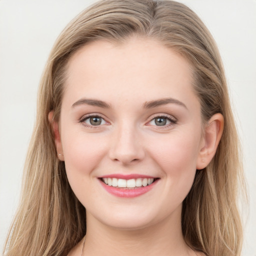 Joyful white young-adult female with long  brown hair and grey eyes