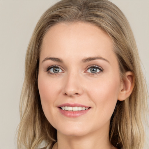 Joyful white young-adult female with long  brown hair and grey eyes