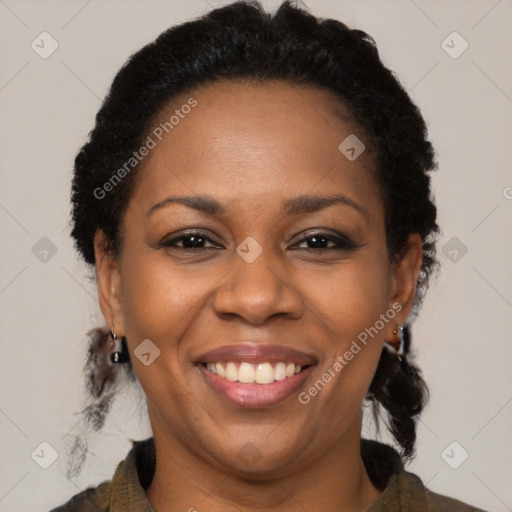 Joyful black adult female with medium  brown hair and brown eyes