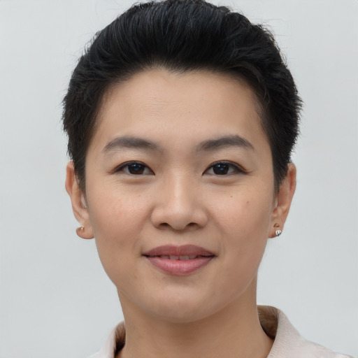 Joyful asian young-adult female with short  brown hair and brown eyes