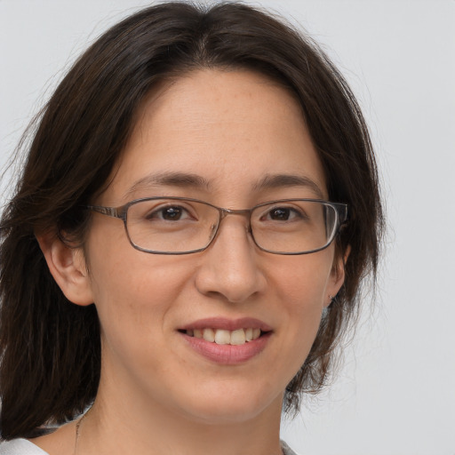 Joyful white adult female with medium  brown hair and brown eyes