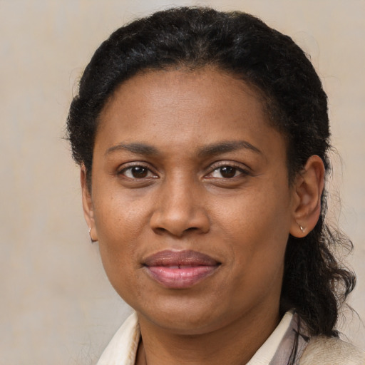 Joyful latino adult female with short  brown hair and brown eyes