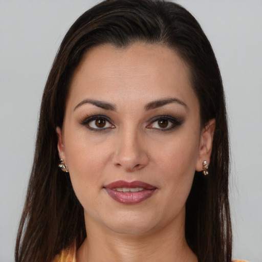 Joyful latino young-adult female with long  brown hair and brown eyes