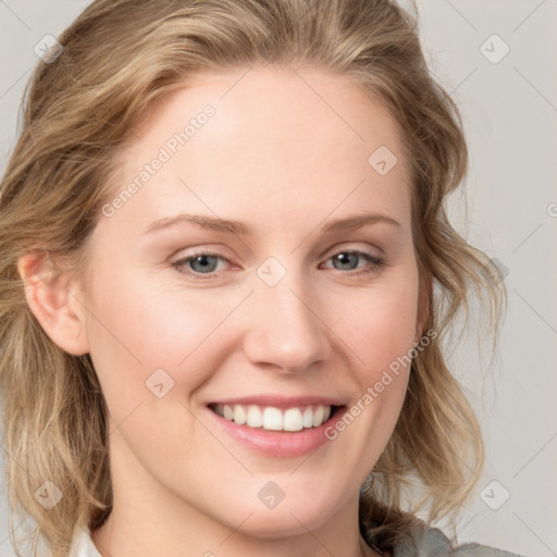 Joyful white young-adult female with medium  brown hair and blue eyes