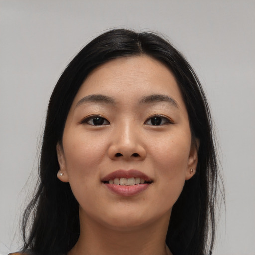 Joyful asian young-adult female with long  black hair and brown eyes