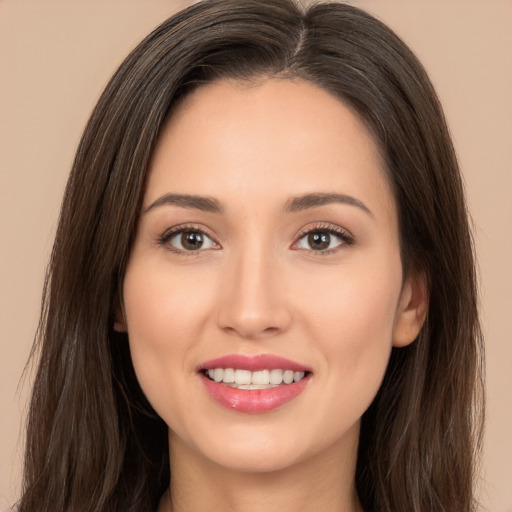 Joyful white young-adult female with long  brown hair and brown eyes