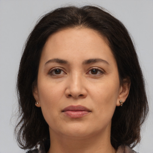 Joyful white adult female with medium  brown hair and brown eyes