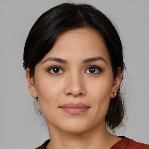 Joyful white young-adult female with medium  black hair and brown eyes