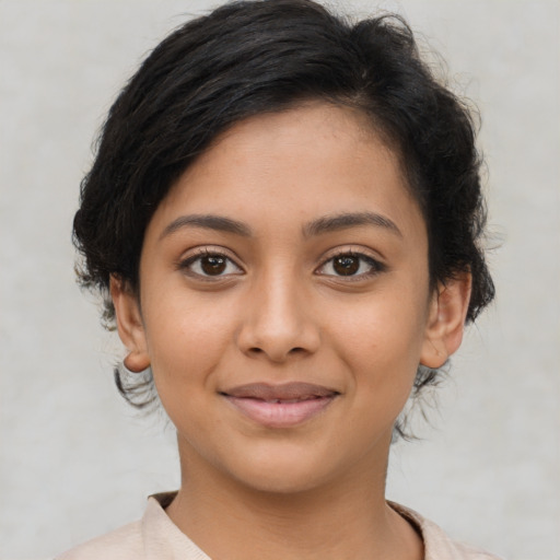 Joyful latino young-adult female with medium  brown hair and brown eyes