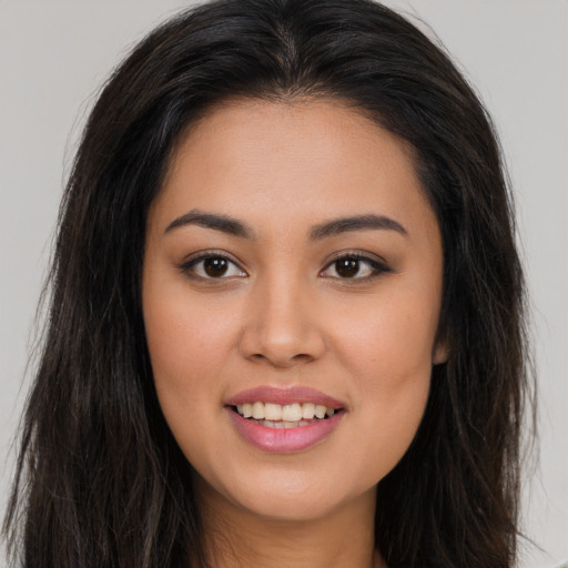 Joyful asian young-adult female with long  brown hair and brown eyes