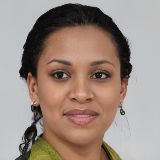 Joyful black young-adult female with short  brown hair and brown eyes