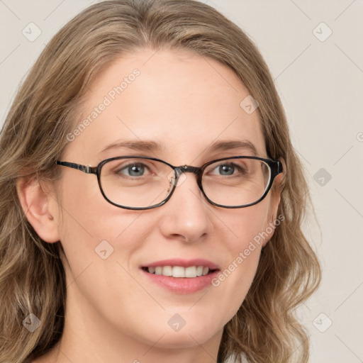 Joyful white young-adult female with long  brown hair and blue eyes