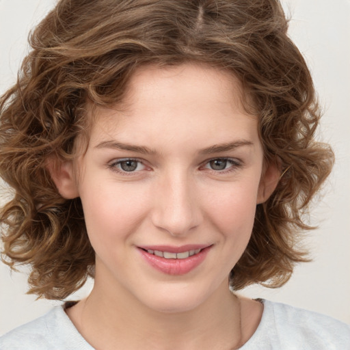 Joyful white child female with medium  brown hair and brown eyes