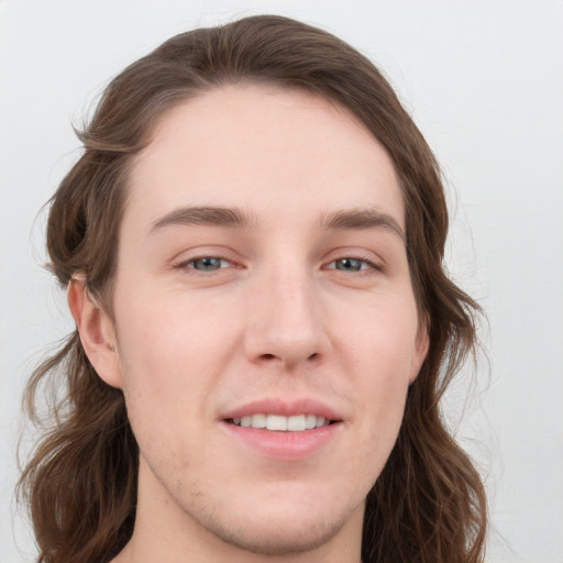 Joyful white young-adult male with medium  brown hair and grey eyes