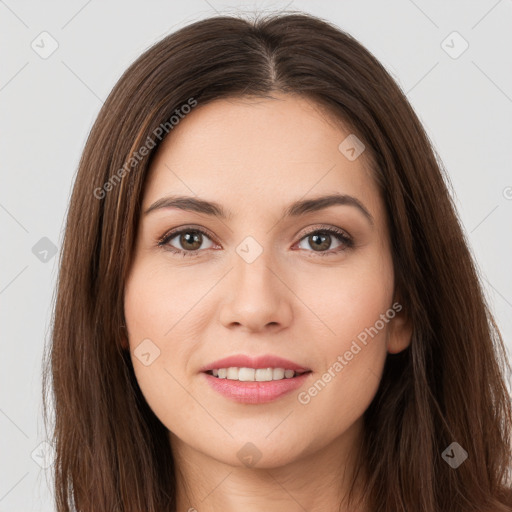 Joyful white young-adult female with long  brown hair and brown eyes