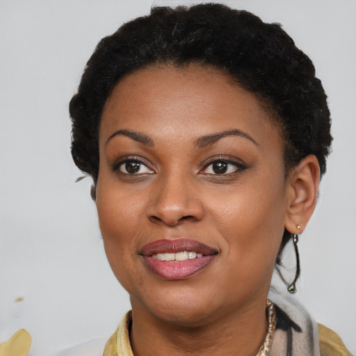 Joyful black young-adult female with short  brown hair and brown eyes