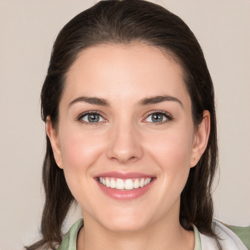 Joyful white young-adult female with medium  brown hair and brown eyes