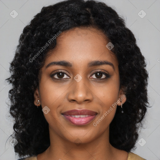 Joyful black young-adult female with long  black hair and brown eyes