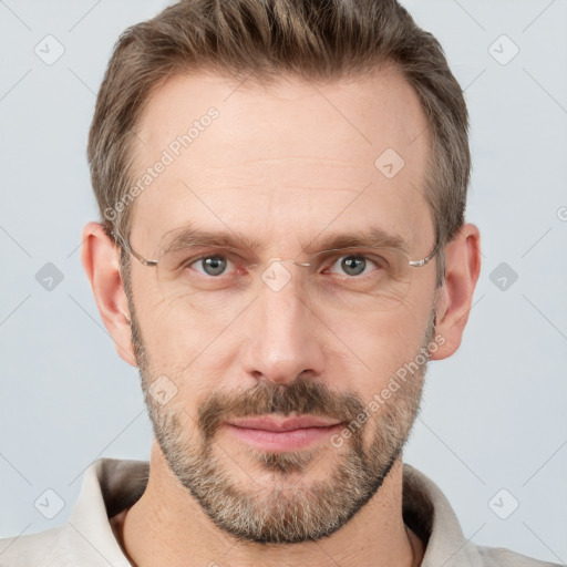 Joyful white adult male with short  brown hair and grey eyes