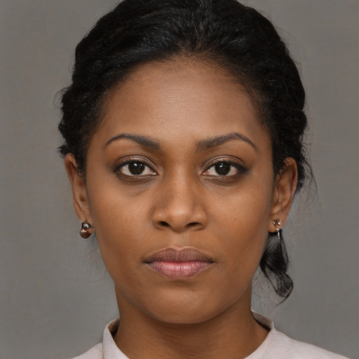 Neutral black young-adult female with medium  brown hair and brown eyes