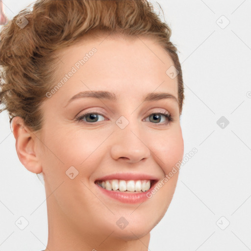 Joyful white young-adult female with short  brown hair and blue eyes