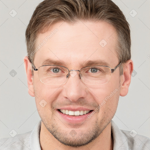 Joyful white adult male with short  brown hair and grey eyes