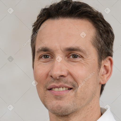 Joyful white adult male with short  brown hair and brown eyes