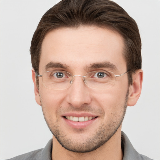 Joyful white young-adult male with short  brown hair and grey eyes