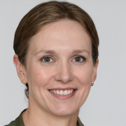 Joyful white young-adult female with short  brown hair and grey eyes