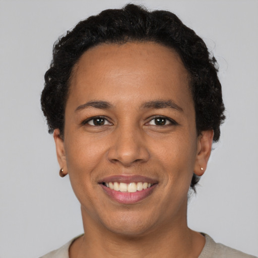 Joyful latino adult female with short  brown hair and brown eyes