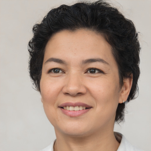 Joyful asian adult female with medium  brown hair and brown eyes