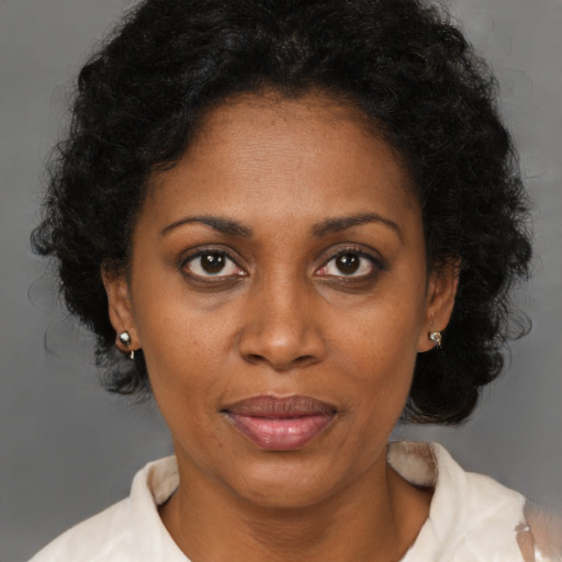 Joyful black young-adult female with medium  brown hair and brown eyes
