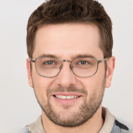 Joyful white young-adult male with short  brown hair and grey eyes