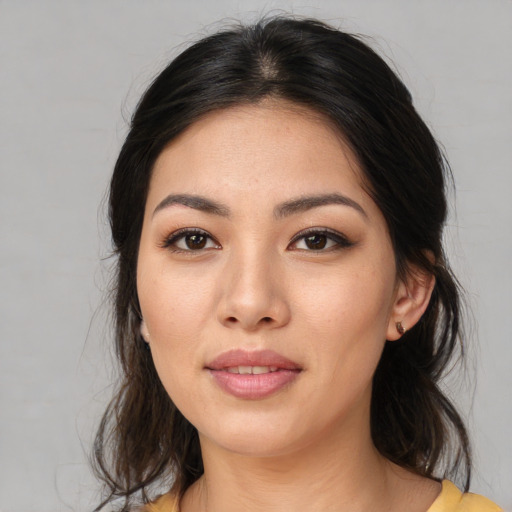 Joyful asian young-adult female with medium  brown hair and brown eyes