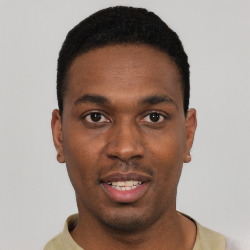 Joyful black young-adult male with short  black hair and brown eyes
