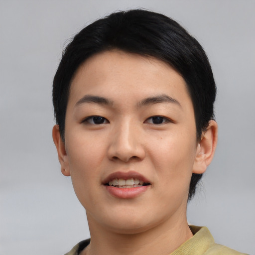 Joyful asian young-adult female with short  black hair and brown eyes
