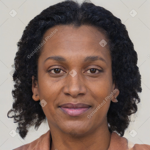 Joyful black adult female with short  brown hair and brown eyes