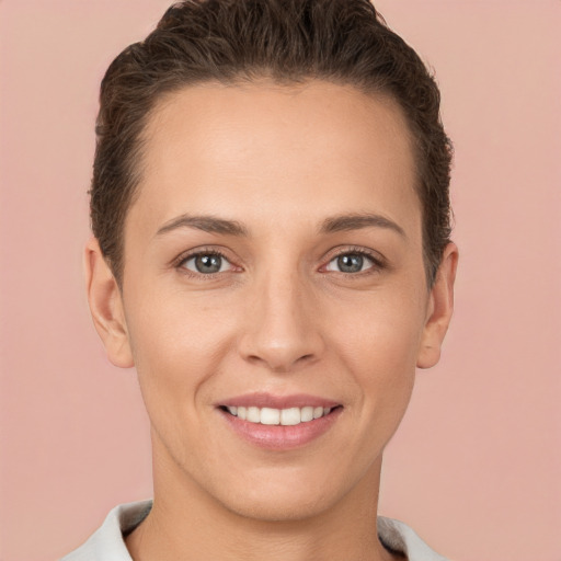 Joyful white young-adult female with short  brown hair and brown eyes