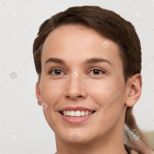 Joyful white young-adult female with short  brown hair and brown eyes