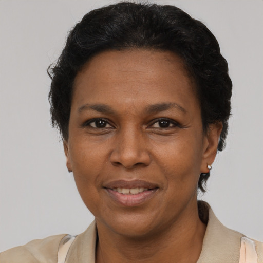 Joyful latino adult female with short  brown hair and brown eyes