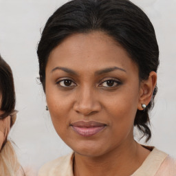 Joyful black young-adult female with medium  brown hair and brown eyes