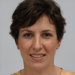 Joyful white adult female with short  brown hair and brown eyes